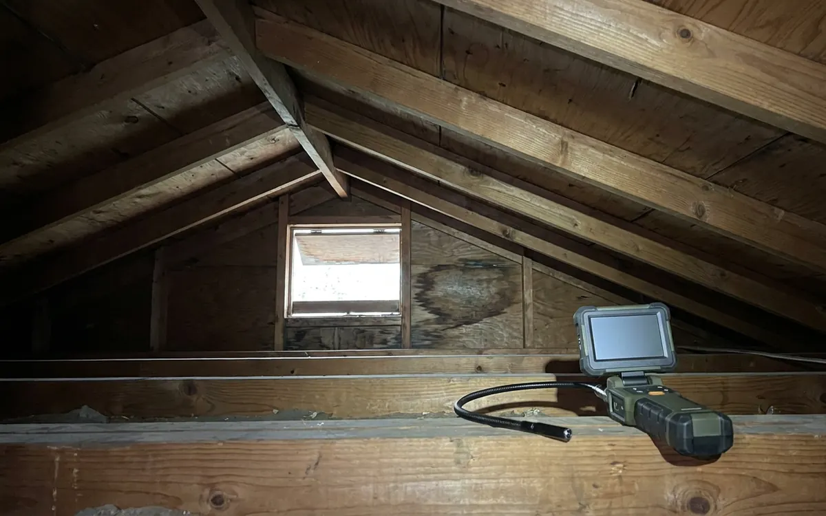 Attic roof decking and inspection camera documenting a condition
