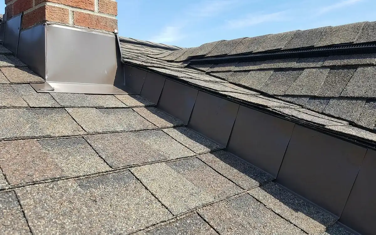Chimney flashing, roof valley, vent boot, shingles, and gutter