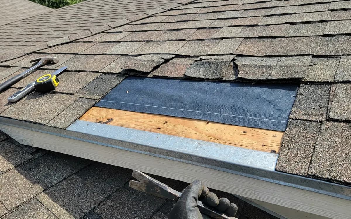 Close view of roof flashing, shingles, and vent details