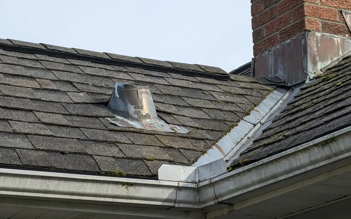 Chimney flashing, roof valley, vent boot, shingles, and gutter