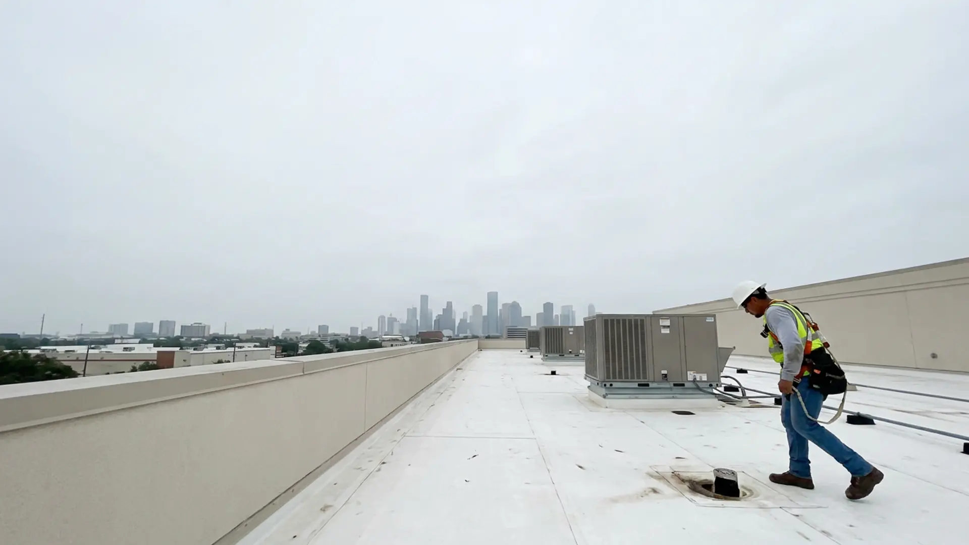 Commercial roof inspector examining a low-slope Houston roof