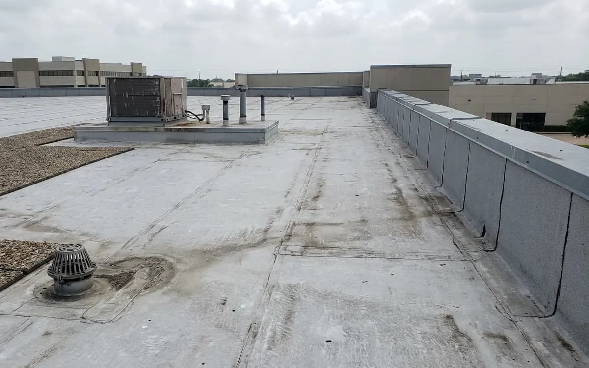 Light-colored TPO membrane and parapet flashing on a commercial roof