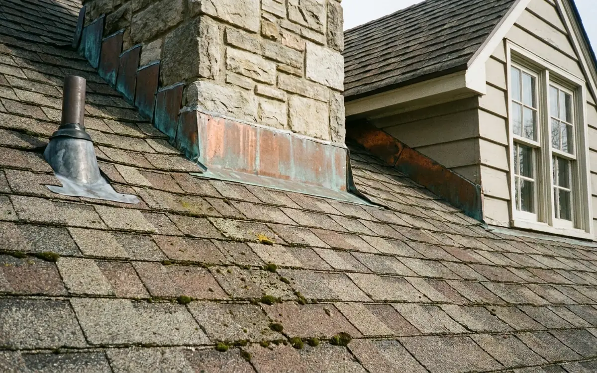 Visible residential roof flashing and shingle details