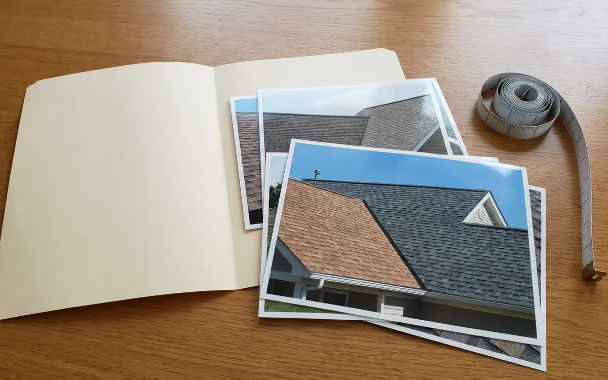 Blank folder with unbranded roof photographs on a table